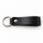 SANTJAG personalized leather keychain in Black leather, unengraved, with silver-tone key ring and rivet on a white background.