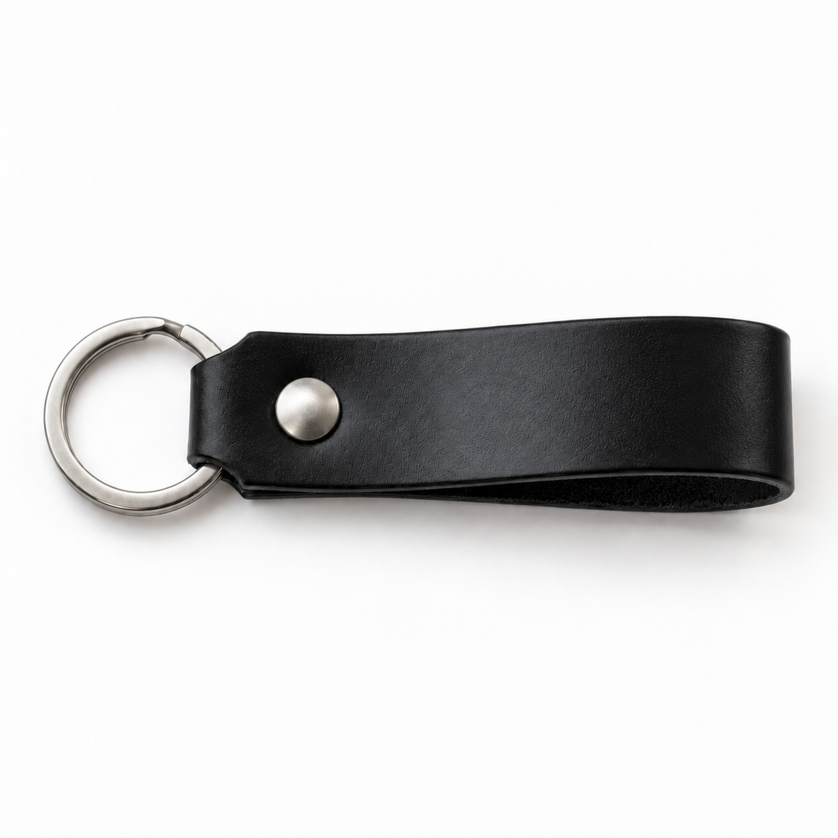 SANTJAG personalized leather keychain in Black leather, unengraved, with silver-tone key ring and rivet on a white background.