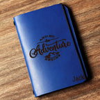 Personalized brown full-grain leather passport cover with laser engraved Vacation Mode On design, elastic band closure, and custom name Nicole engraved at bottom corner.